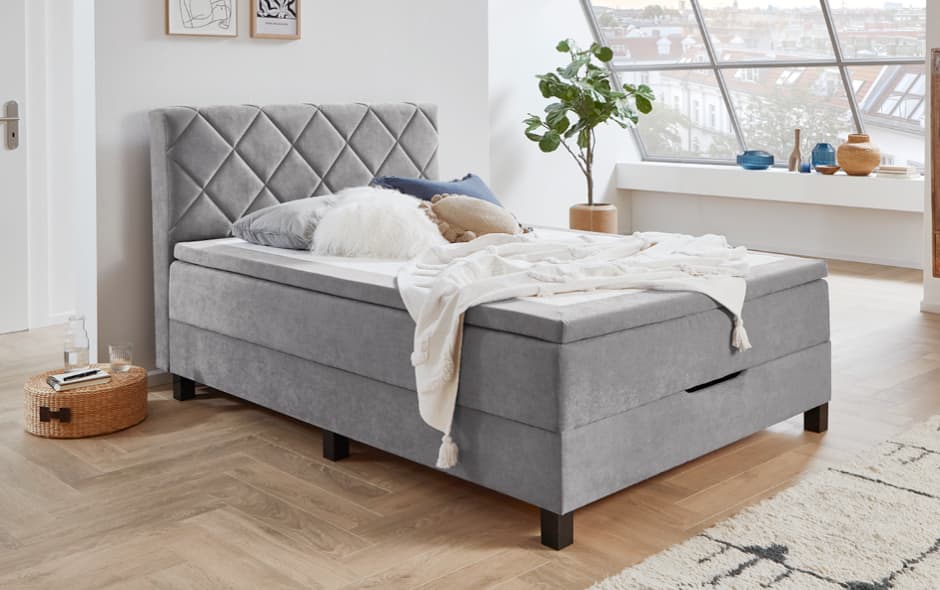 elegantes polsterbett in grau mit gestepptem kopfteil und stauraumfunktion