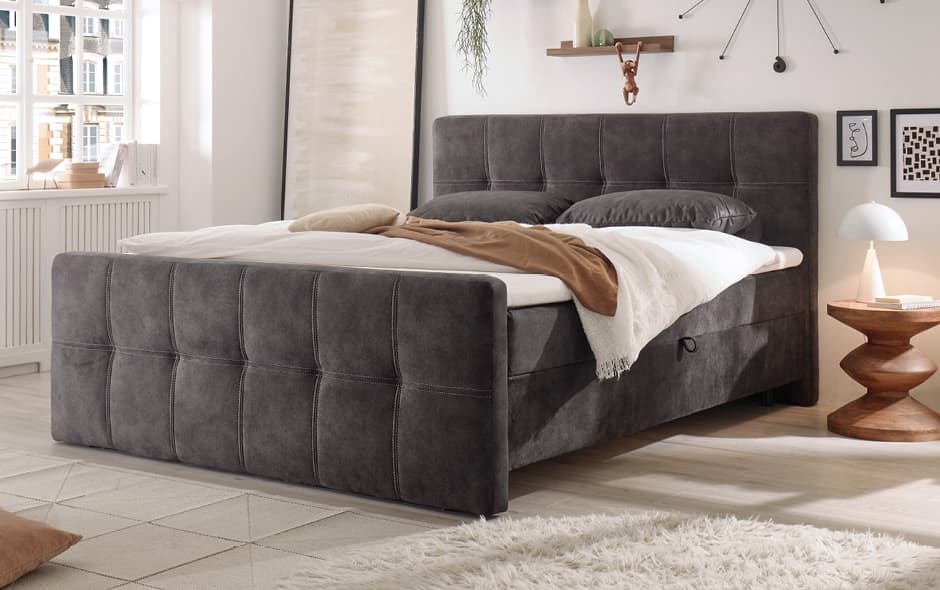 komfortables polsterbett in dunkelgrau mit umlaufender steppung