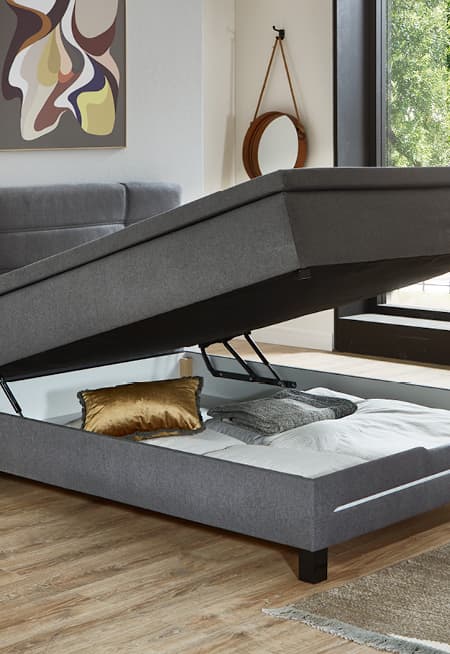 polsterbett mit praktischem bettkasten und grauem stoffbezug